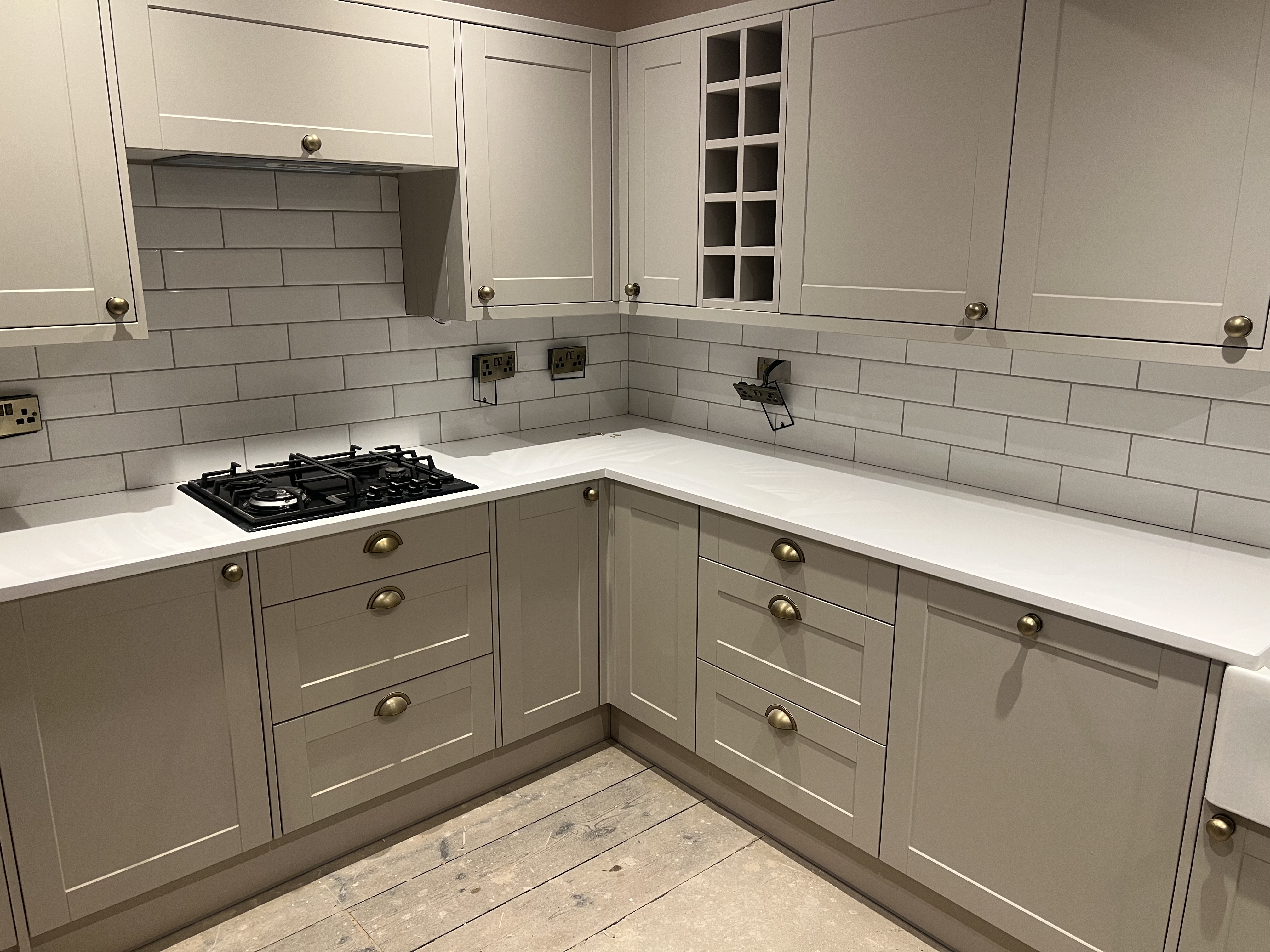 Fitted kitchen with tiled back splash